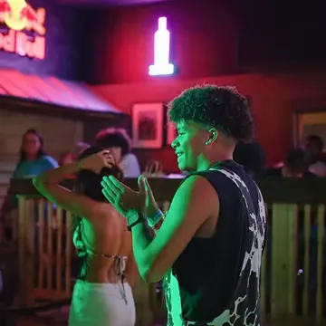 Two dancers by the bar rail